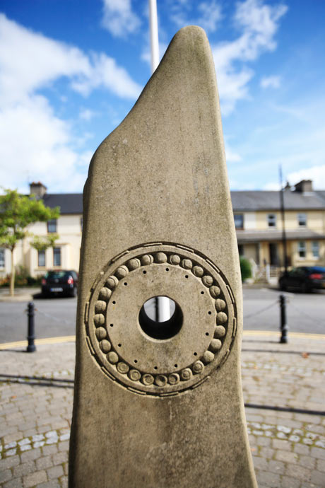 close up photo of the stone moon sculpure with square in the background