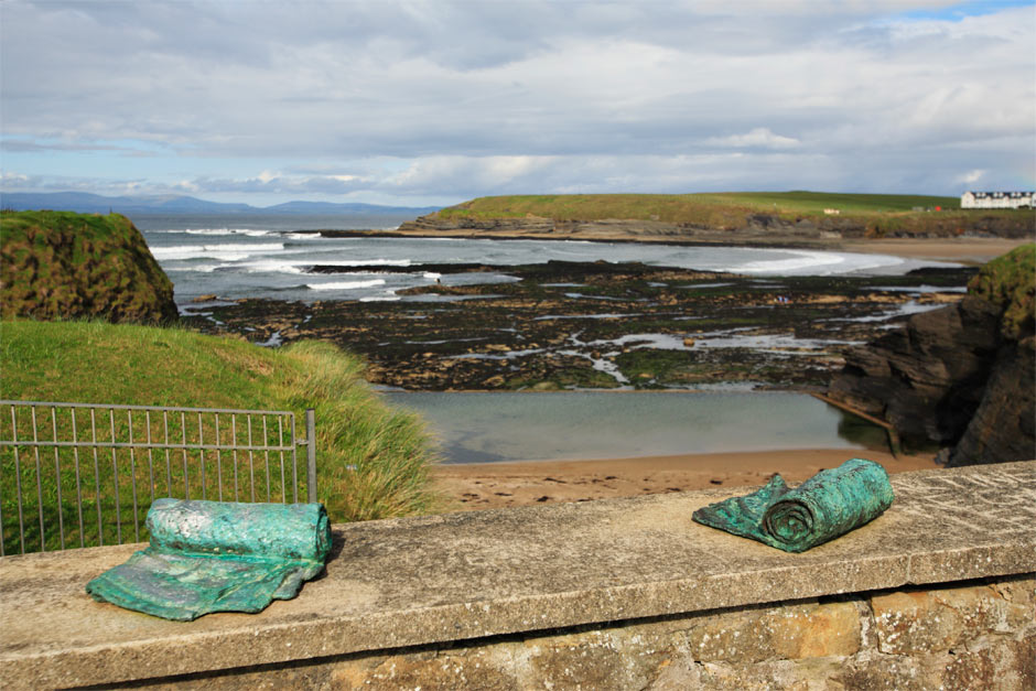 photo of two Dry sculpures on a wall over looking the sea