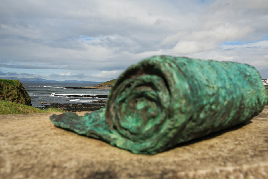 close up photo of bronze sculpture of a rolled up towel