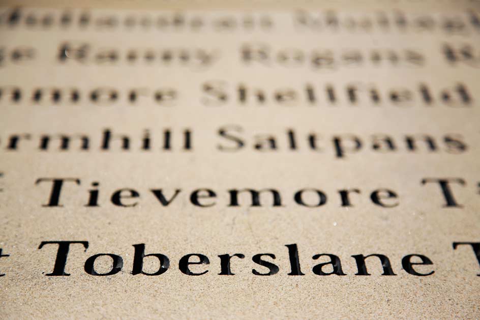 close up of text carved into stone Map wall